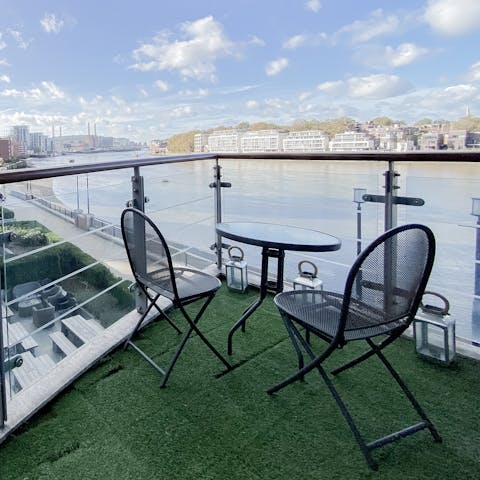 Watch the river flow past on the private balcony