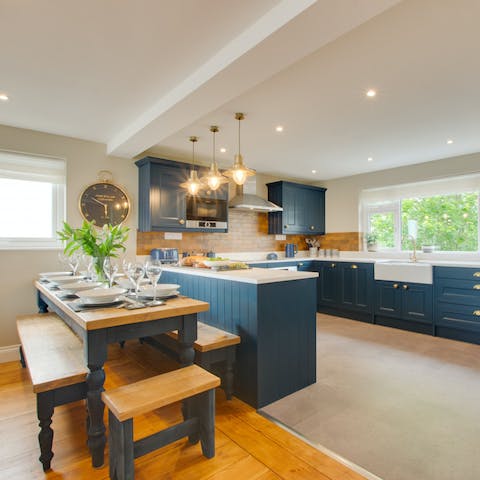 Sit down for a convivial meal in sleek navy blue kitchen come dining area