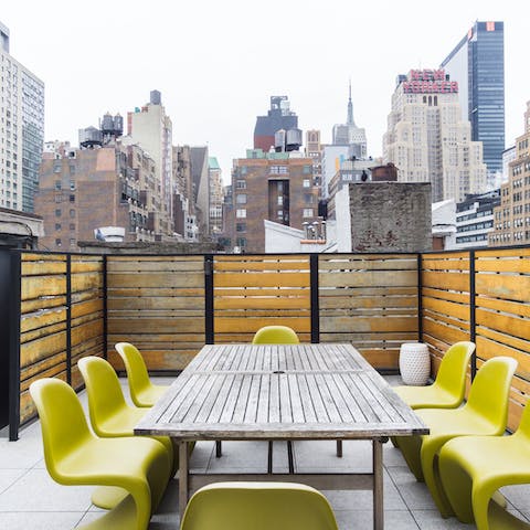 Head up to the shared roof terrace and watch the sunset over the city