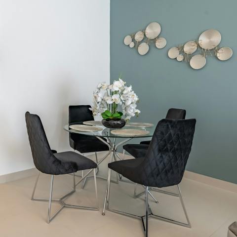 Gather around the sleek glass dining table for an intimate dinner