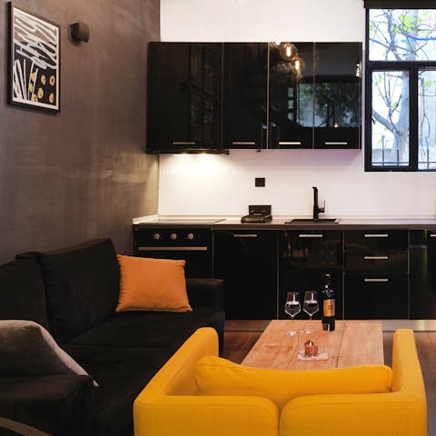 Pour yourself a glass of Greek wine and chill out in the trendy living area