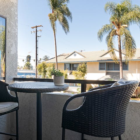 Relax with a drink and a good book out on the private balcony