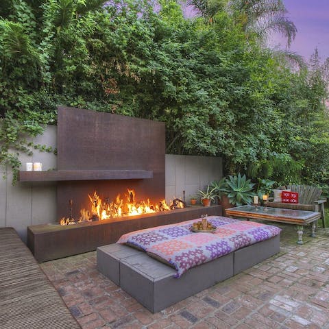 Get cosy beside the outdoor fireplace