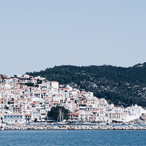 Explore Skopelos Town, a ten-minute drive away