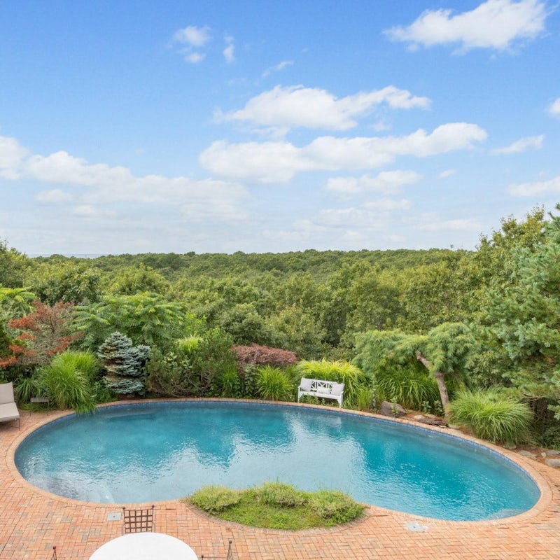 Dive from the greens of the view into the blue of your pool
