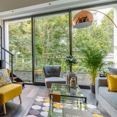 Bask in the greenery from the floor to ceiling windows in the living room