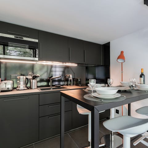 Start the day with a strong coffee and a croissant in the sleek, black kitchen