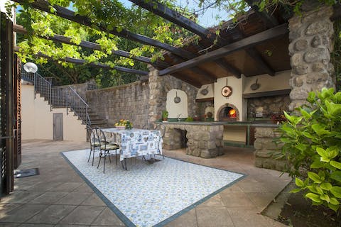 Fire up the pizza oven and dine alfresco under the pergola