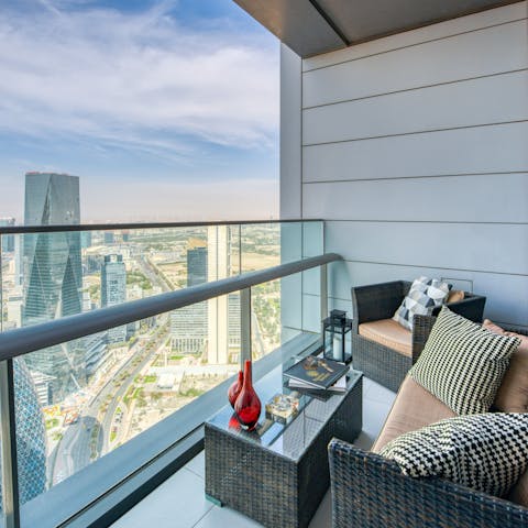 Gaze out at stunning skyline views from the lounge area on your private balcony