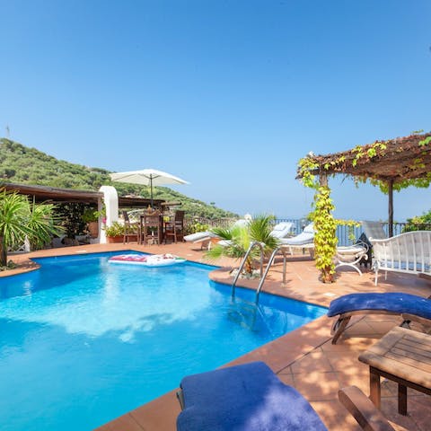 Splash about in the villa's swimming pool and dry off on one of the loungers