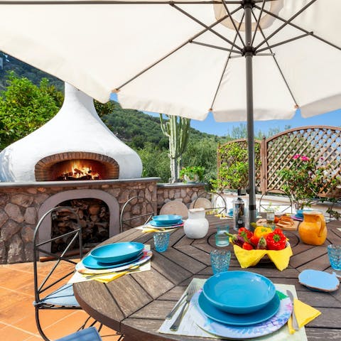 Work culinary magic on the barbecue and wood-burning stove on the terrace