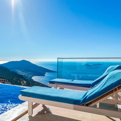Lay out on a sun lounger with unparalleled views of the island below