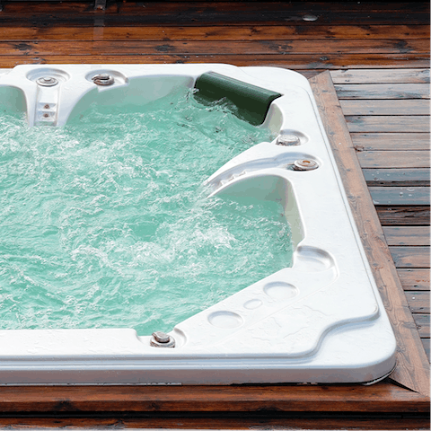 Have a relaxing soak in the backyard hot tub