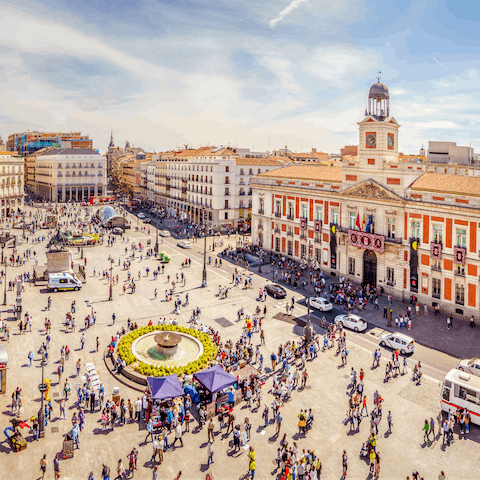 Stroll through bustling Puerta del Sol, twenty-five minutes away on foot