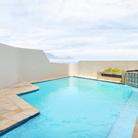 Take a relaxing dip in the communal pool on a hot summer day