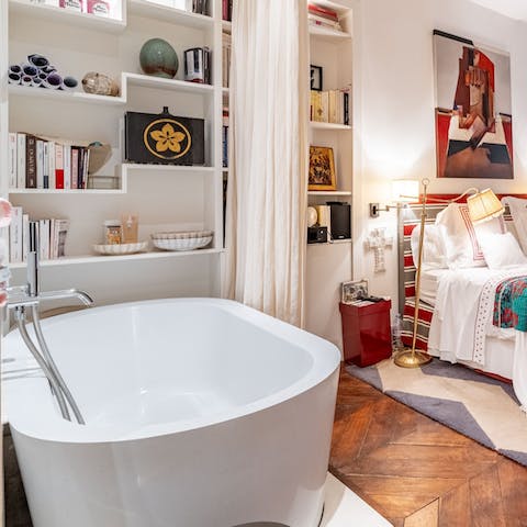Relax with a glass of wine in the en-suite bathtub after exploring Paris