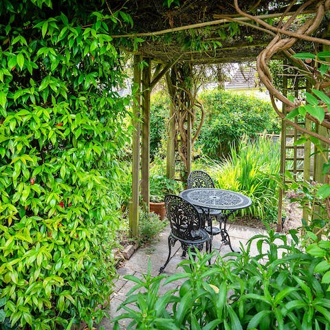Enjoy your morning coffee under the vine-covered pergola