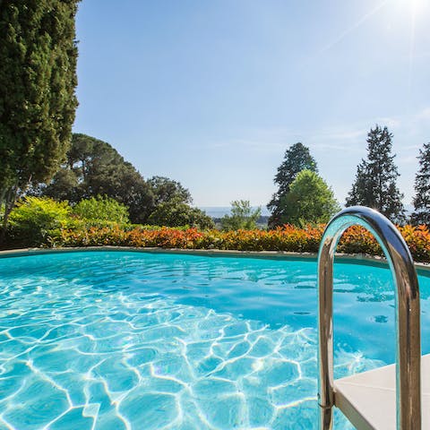 Peek at the Tuscan hills in the distance from the cool of the pool