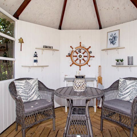 Enjoy cocktail hours in the nautical-themed summer house