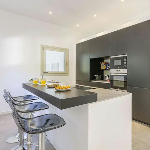 Gather around the kitchen island to prepare meals together as a group while chatting and sipping wine