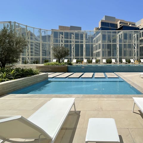 Soak up the Dubai sunshine from communal swimming pool