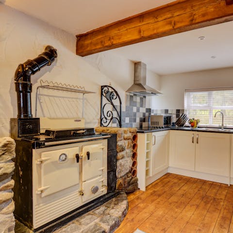 Admire classic countryside features like the rustic Aga and wooden beams