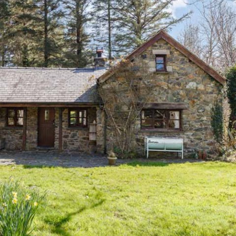 Enjoy a picnic on the lawn in front of the gorgeous stone cottage