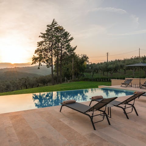 Relax on a poolside lounger while gazing out at the countryside views