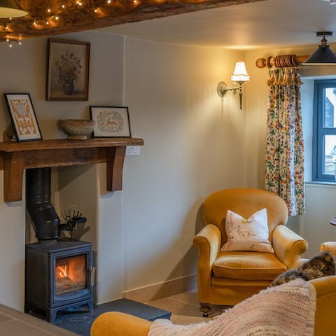 Cosy up by the living room's fire with a glass of wine