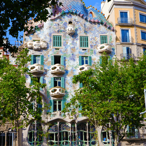 Admire the striking facade of Casa Batlló, about twenty minutes away by metro