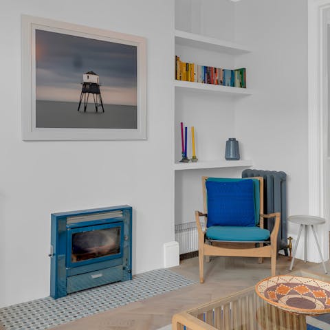 Cosy up next to the fireplace in the colourful lounge