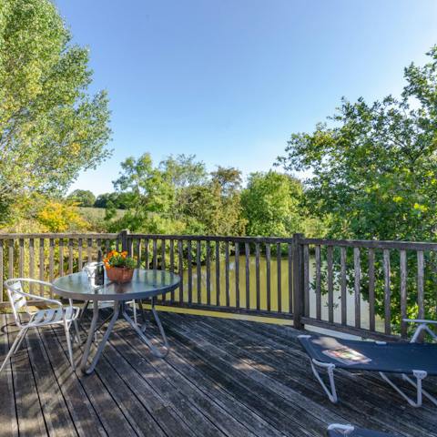 Relax on the lovely decked patio overlooking the pond