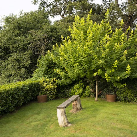 Enjoy a secluded moment at the bottom of the garden