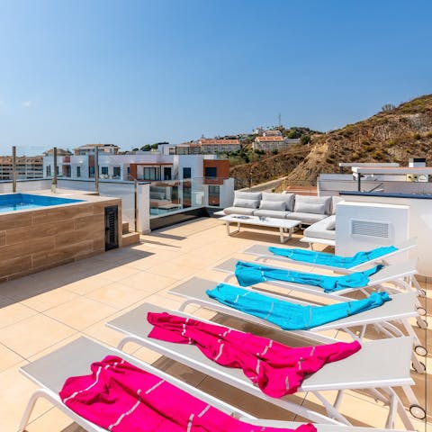 Lie back on the row of sun loungers and catch some sun up on the roof