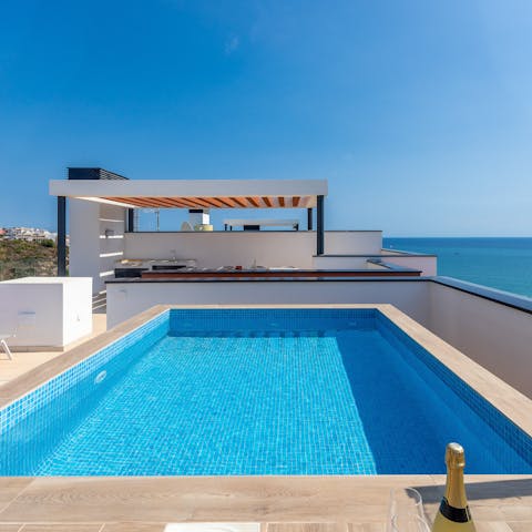 Start your day with a dip in the private rooftop pool under clear blue skies