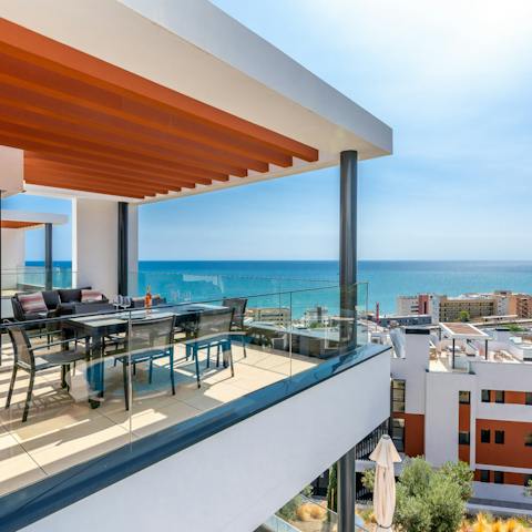 Enjoy fantastic views across the sea and city as you dine and relax on the balcony