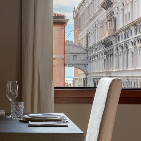 Marvel at the incredible view of the Bridge of Sighs from your dining room window as gondolas float by on the canal