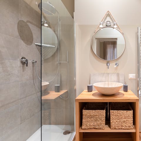 Rinse off and relax sore muscles underneath the luxurious rainfall showers
