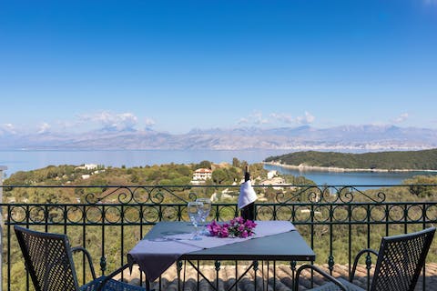 Admire the gorgeous views from the balcony, glass of wine in hand
