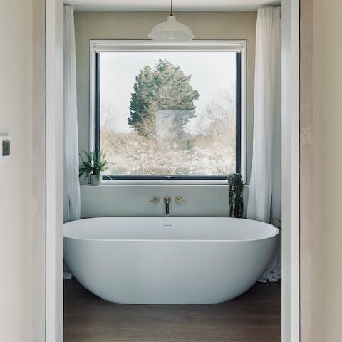 Savour beautiful views while relaxing in the bath