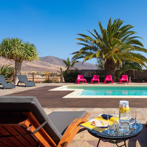 Admire the volcanic landscape from your private pool