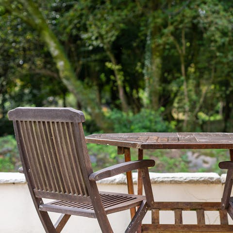Enjoy a seat in the sun on the cottage's patio overlooking the walled garden