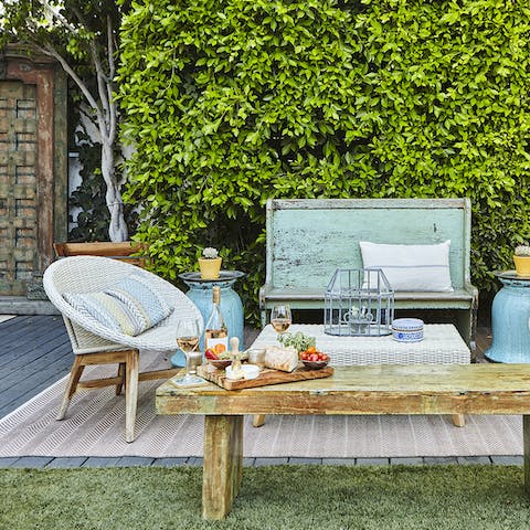 Open a bottle of wine to enjoy on the shabby chic patio set 