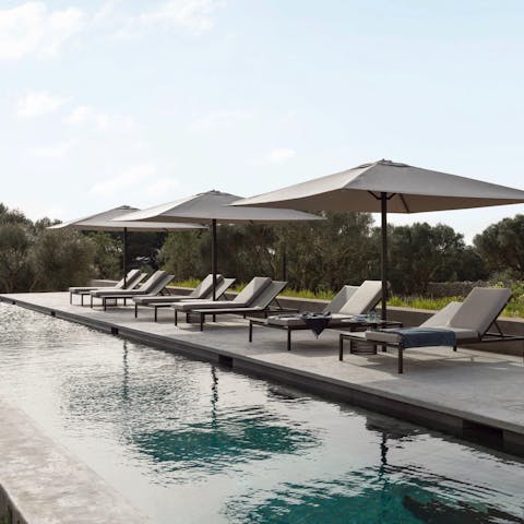 Lounge beside the private salt-water pool with a cocktail