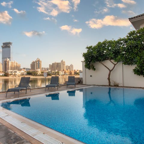 Take a dip in the glassy private pool by the water