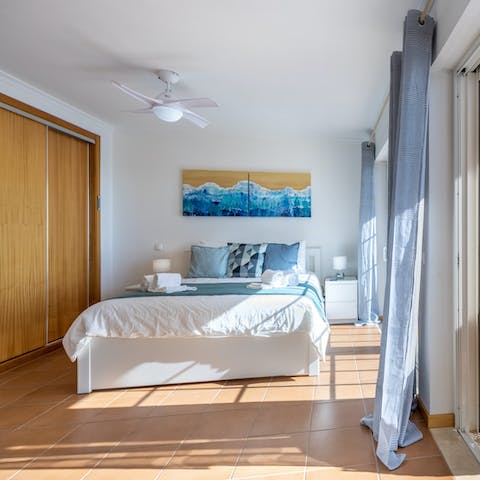 Wake up to sea views and natural light in the comfortable main suite 