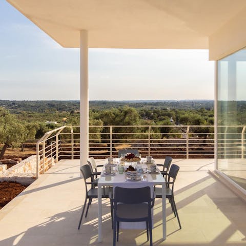 Enjoy a local bottle of red on the terrace overlooking the olive groves of the Itria Valley