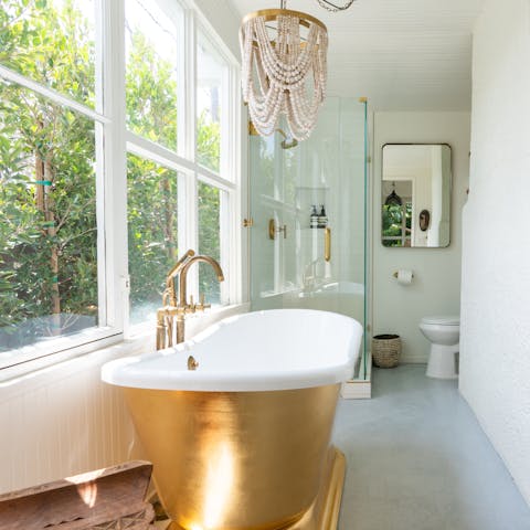 Take a long luxurious soak in the sparkling gold tub