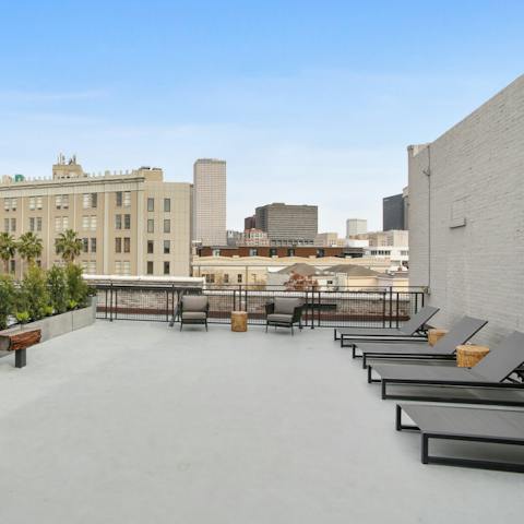 Enjoy a drink on the rooftop terrace with skyline views of the city