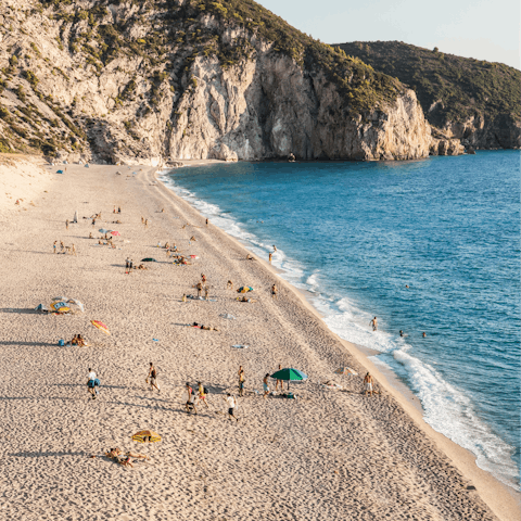 Walk down the steps to Milos Beach to paddle in the shallows